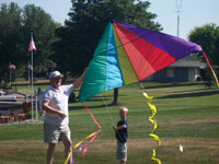 Murfreesboro back pain free grandpa and grandson playing with a kite